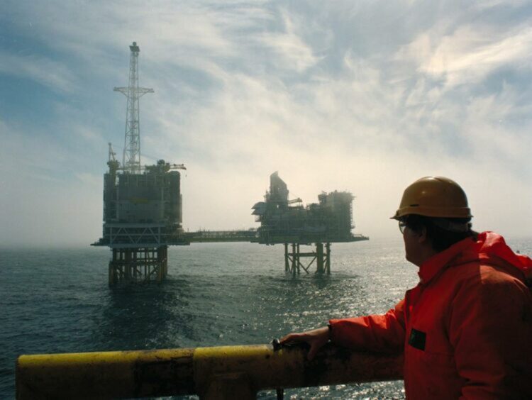 A worker looks out at BP's ETAP platform in the North Sea