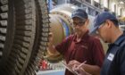 EthosEnergy workers with a gas turbine.