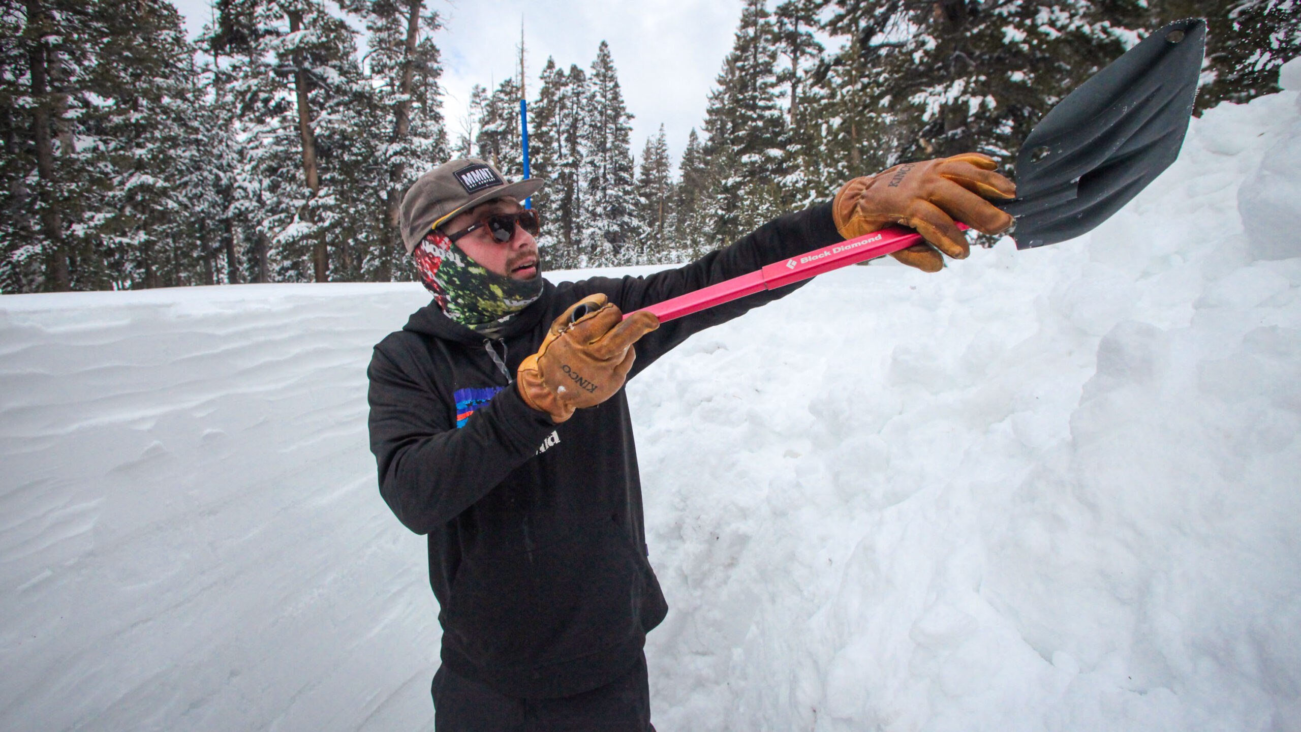 a person with raising a snow shovel up at head height