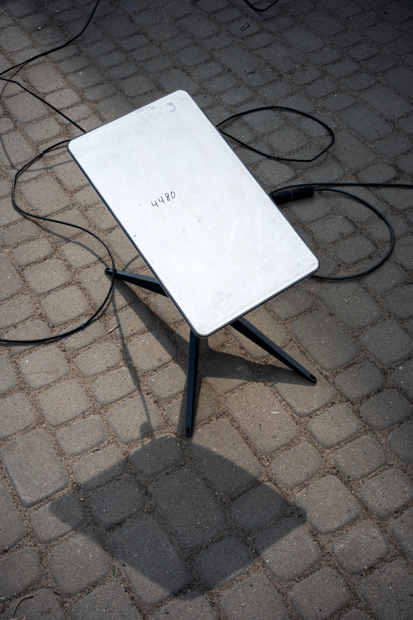 A repaired and mounted Starlink terminal standing on a cobbled road