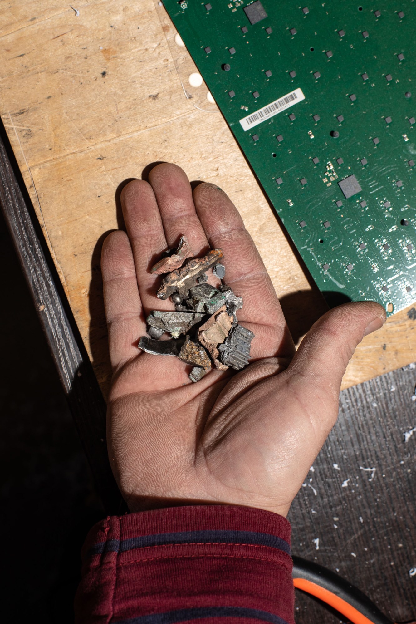 a hand holding pieces of shrapnel