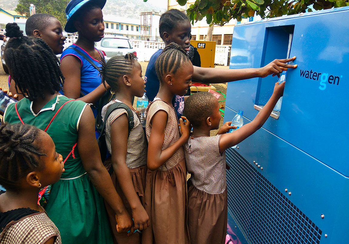 children in queue at a blue Watergen dispenser
