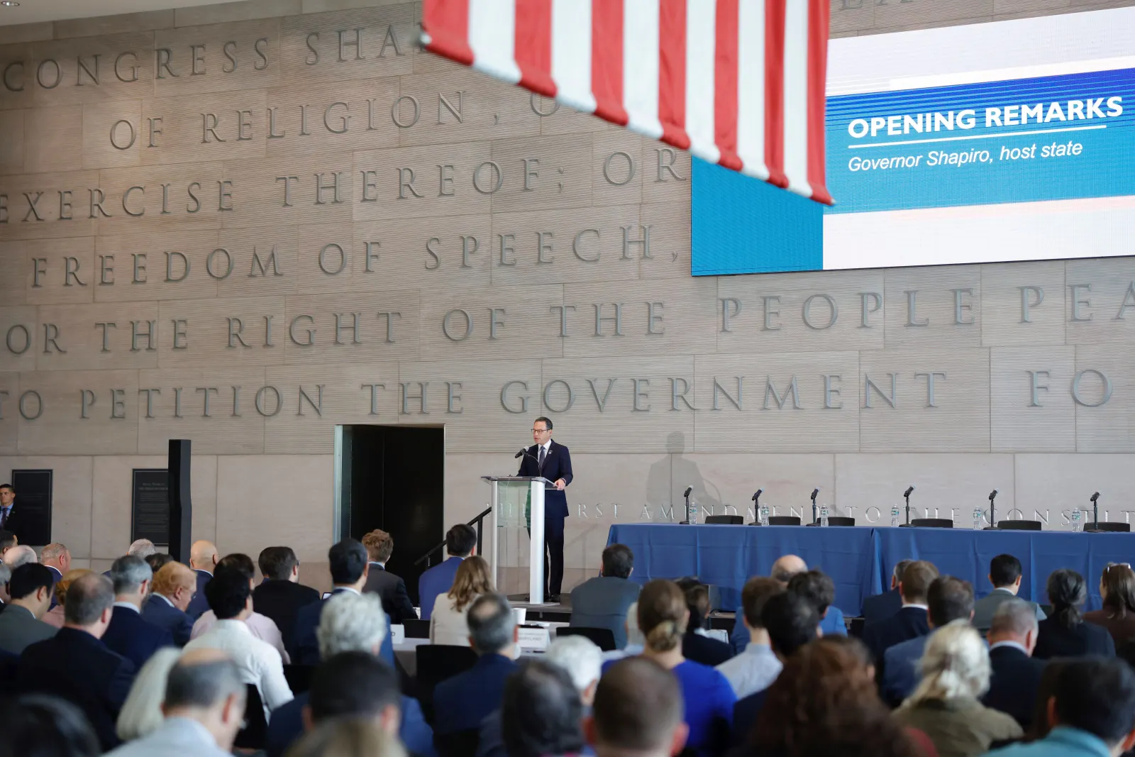 A man speaks at a podium.