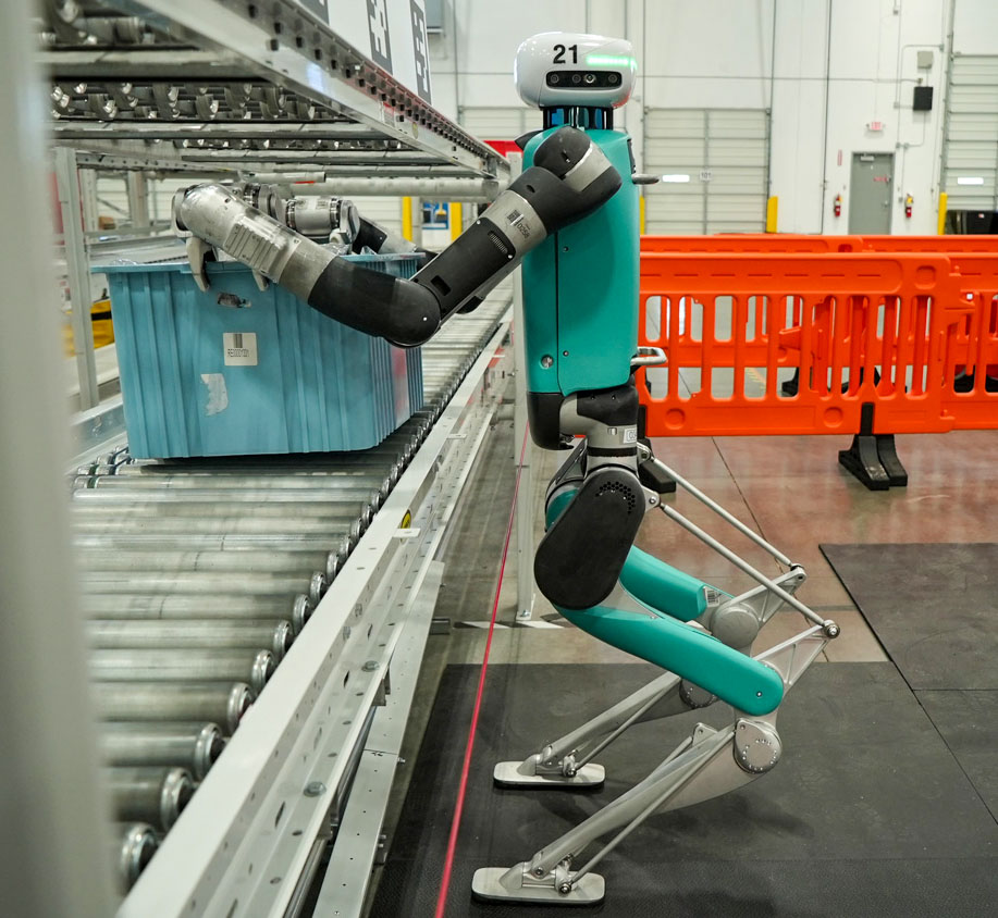 Digit humanoid robot putting a plastic bin on a conveyor belt