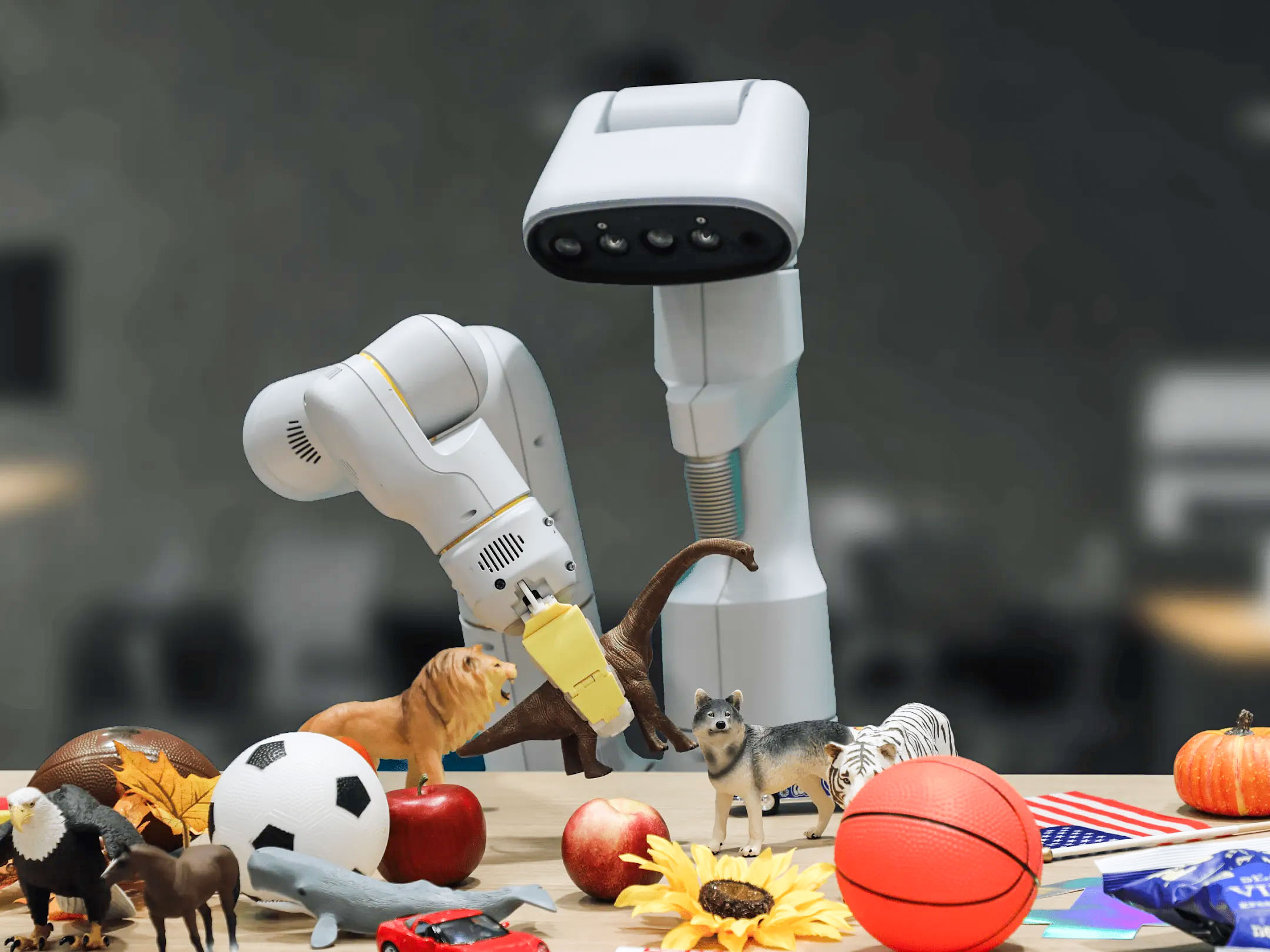 a robot at a table of small toys