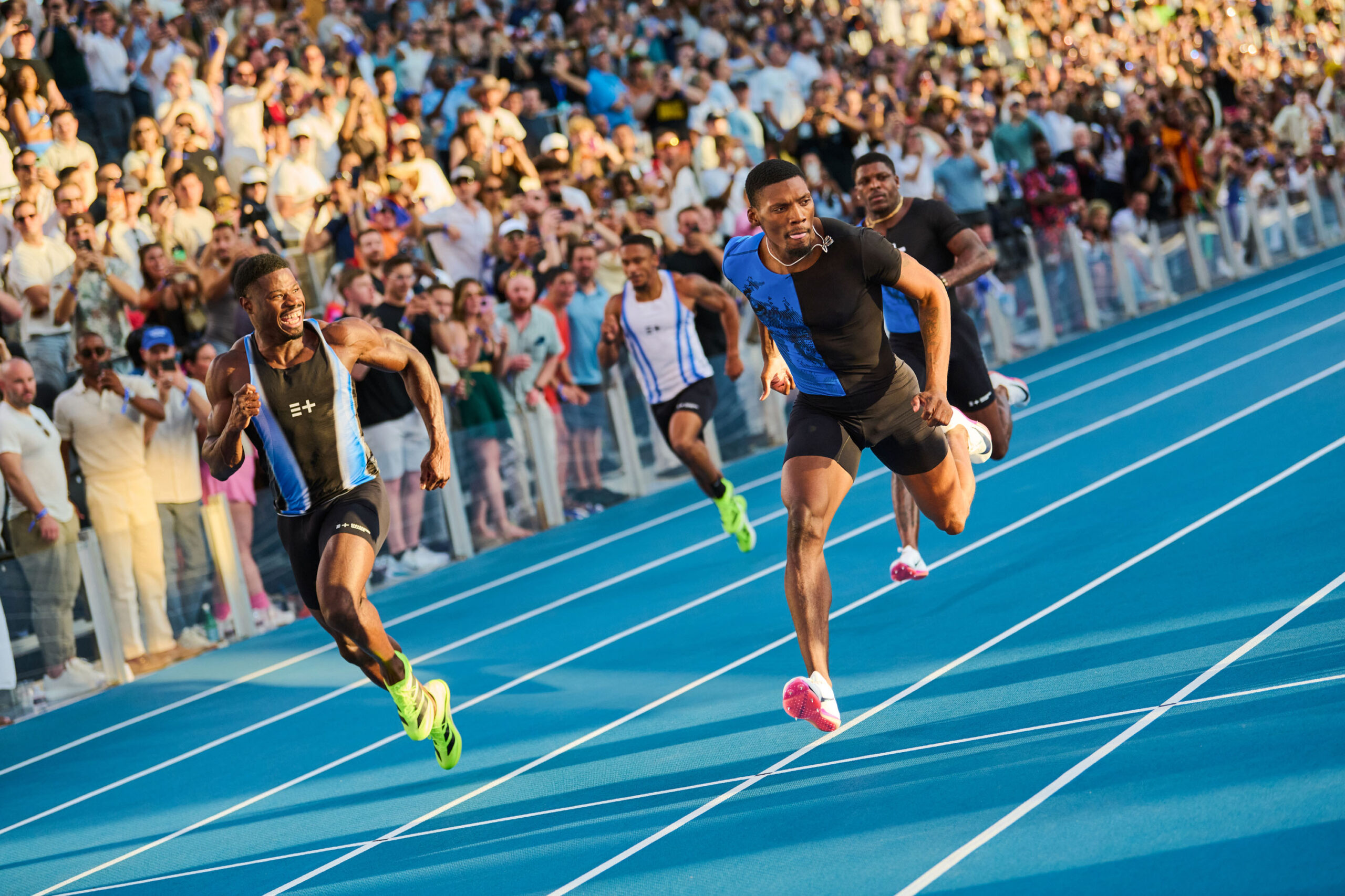 Emmanuel Matadi (left) and Fred Kerley (right) running on the track