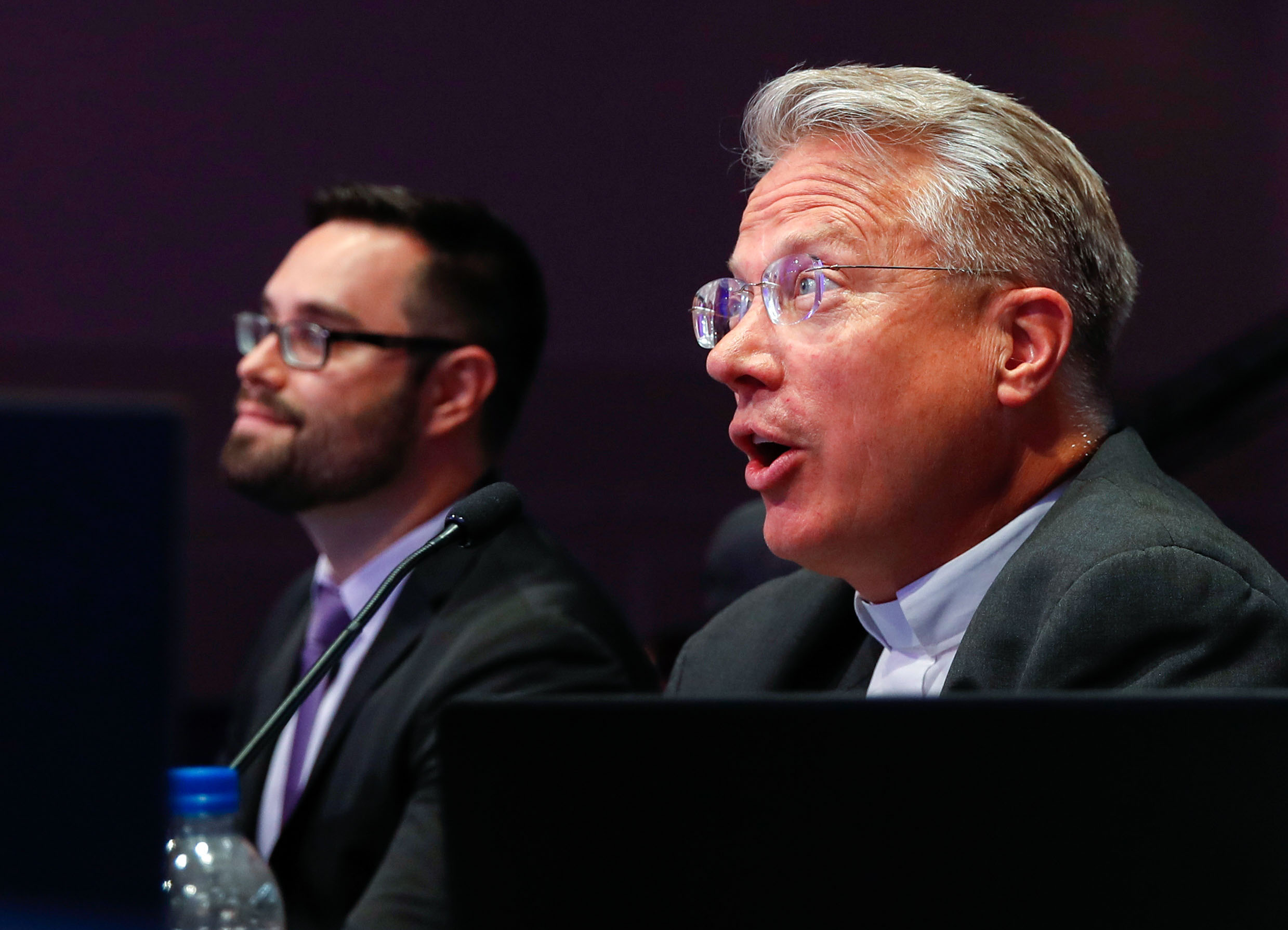 Pronouncer Brian Sietsema, right, speaks during the 3rd Round of the Scripps National Spelling Bee