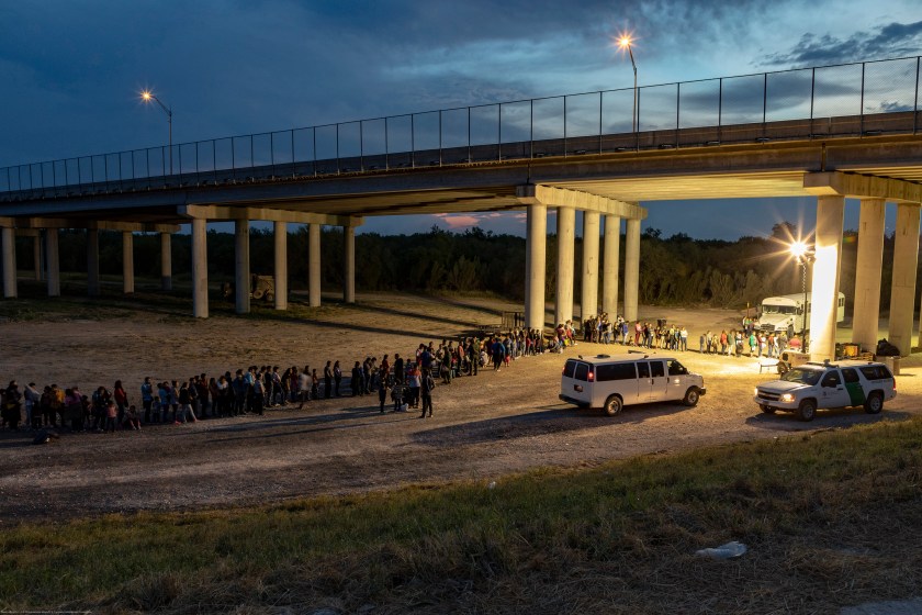 As the sun sets near McAllen TX, migrants that have crossed the Rio Grande surrender to U.S. Border Patrol near an area known as Rincon.